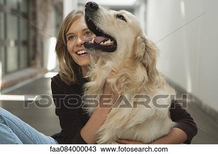 Teenage girl petting golden retriever View Large Photo Image Stock Image - Teenage girl petting golden retriever. Fotosearch