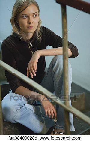 Teenage girl sitting on steps, looking away in thought View Large Photo Image Stock Photography - Teenage girl sitting on steps, looking away in thought. Fotosearch