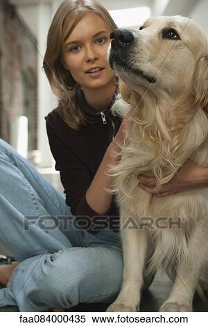 Teenage girl sitting with golden retriever View Large Photo Image Stock Photography - Teenage girl sitting with golden retriever. Fotosearch