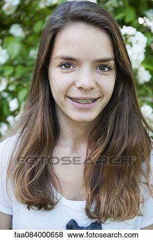 Stock Photo - Teenage girl with braces, portrait. Fotosearch