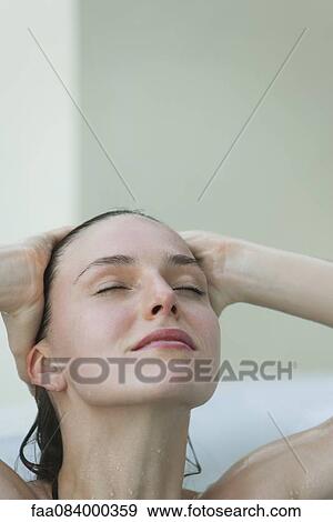 Stock Photo - Woman bathing with eyes closes. Fotosearch