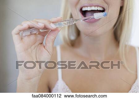 Woman brushing her teeth, cropped View Large Photo Image Stock Image - Woman brushing her teeth, cropped. Fotosearch