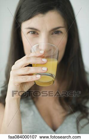 Stock Photo - Woman drinking glass of juice. Fotosearch