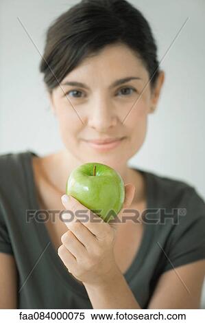 Woman holding green apple View Large Photo Image Stock Photography - Woman holding green apple. Fotosearch