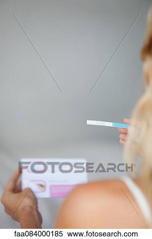 Woman holding pregnancy test, cropped View Large Photo Image Stock Photography - Woman holding pregnancy test, cropped. Fotosearch