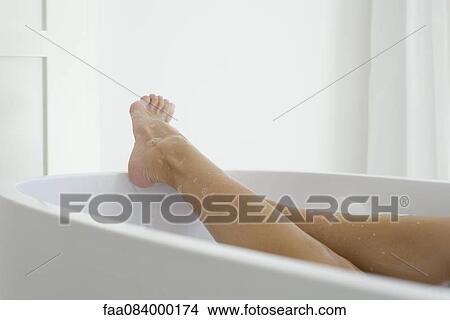 Woman relaxing in bath, low section View Large Photo Image Picture - Woman relaxing in bath, low section. Fotosearch