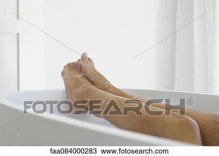 Woman relaxing in bath, low section View Large Photo Image Stock Image - Woman relaxing in bath, low section. Fotosearch