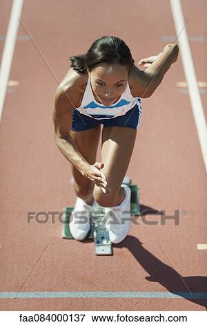 Woman running at starting line View Large Photo Image Stock Photo - Woman running at starting line. Fotosearch