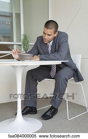 Young businessman watering bonsai tree View Large Photo Image Stock Photography - Young businessman watering bonsai tree. Fotosearch