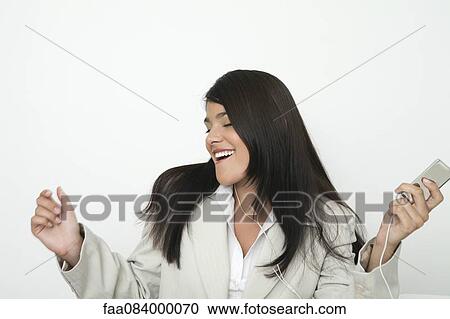 Young businesswoman listing to music on mp3 player View Large Photo Image Stock Image - Young businesswoman listing to music on mp3 player. Fotosearch