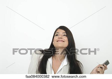 Young businesswoman listing to music on mp3 player View Large Photo Image Stock Image - Young businesswoman listing to music on mp3 player. Fotosearch