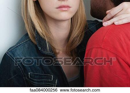 Stock Photograph - Young couple embracing, cropped. Fotosearch