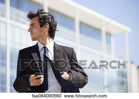 Stock Image - Young executive outdoors. Fotosearch