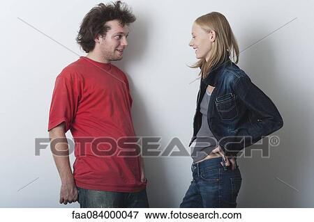 Young man and young woman talking together View Large Photo Image Stock Photo - Young man and young woman talking together. Fotosearch