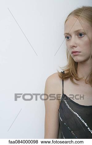 Stock Photo - Young woman looking away, portrait. Fotosearch