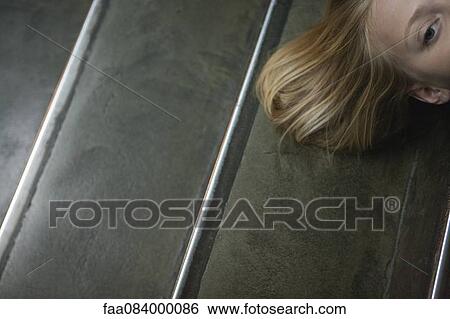 Young woman lying on stairs, cropped View Large Photo Image Stock Photograph - Young woman lying on stairs, cropped. Fotosearch