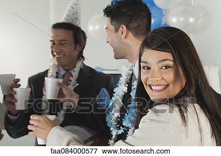 Young woman making a toast with colleagues at office celebration View Large Photo Image Stock Photo - Young woman making a toast with colleagues at office celebration. Fotosearch