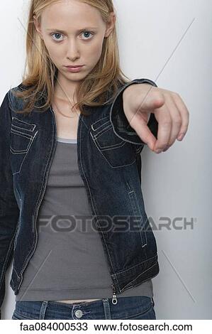 Young woman pointing finger accusingly at camera View Large Photo Image Stock Image - Young woman pointing finger accusingly at camera. Fotosearch