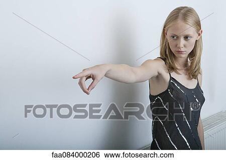 Stock Photograph - Young woman pointing finger. Fotosearch