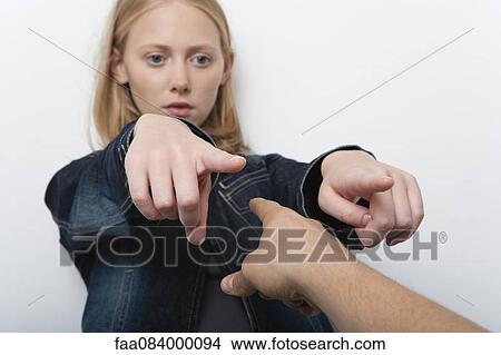 Young woman pointing fingers accusingly at person in foreground View Large Photo Image Picture - Young woman pointing fingers accusingly at person in foreground. Fotosearch
