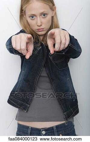Young woman pointing fingers accusingly at camera View Large Photo Image Stock Image - Young woman pointing fingers accusingly at camera. Fotosearch