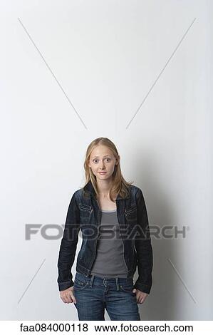 Stock Photo - Young woman smiling cheerfully, portrait. Fotosearch