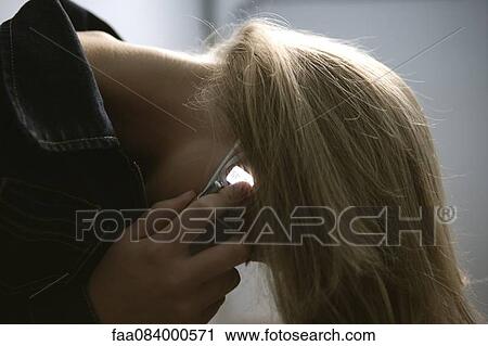 Young woman tossing hair while talking on cell phone View Large Photo Image Stock Image - Young woman tossing hair while talking on cell phone. Fotosearch
