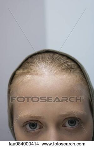Picture - Young woman wearing hood, cropped portrait. Fotosearch