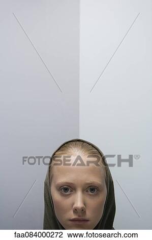 Young woman wearing hood, portrait View Large Photo Image Stock Image - Young woman wearing hood, portrait. Fotosearch