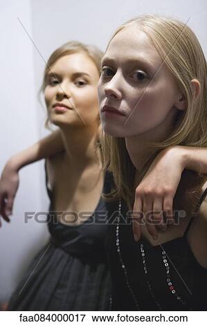 Young woman with arm around friend's shoulder, portrait View Large Photo Image Stock Photo - Young woman with arm around friend's shoulder, portrait. Fotosearch