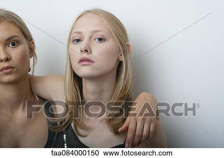 Young woman with arm around girlfriend's shoulder, portrait View Large Photo Image Stock Image - Young woman with arm around girlfriend's shoulder, portrait. Fotosearch