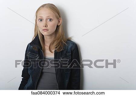 Picture - Young woman with eyes opened wide in surprise, portrait. Fotosearch