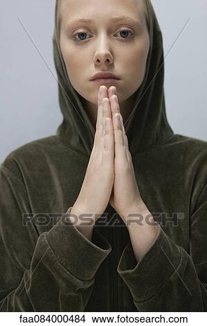 Young woman with hands clasped in prayer, portrait View Large Photo Image Picture - Young woman with hands clasped in prayer, portrait. Fotosearch