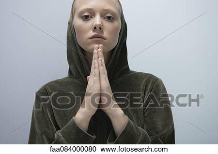 Young woman with hands clasped in prayer, portrait View Large Photo Image Stock Image - Young woman with hands clasped in prayer, portrait. Fotosearch