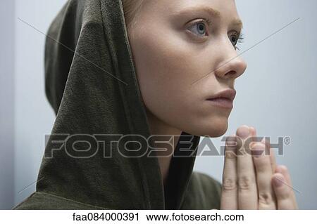 Young woman with hands clasped in prayer, portrait View Large Photo Image Stock Image - Young woman with hands clasped in prayer, portrait. Fotosearch