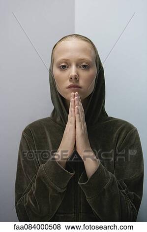 Young woman with hands clasped in prayer, portrait View Large Photo Image Stock Photo - Young woman with hands clasped in prayer, portrait. Fotosearch