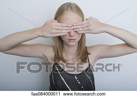 Young woman with hands covering eyes View Large Photo Image Stock Image - Young woman with hands covering eyes. Fotosearch
