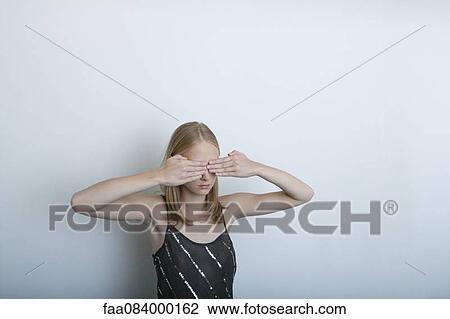 Young woman with hands covering eyes View Large Photo Image Stock Image - Young woman with hands covering eyes. Fotosearch