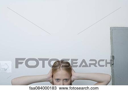 Young woman with hands over ears View Large Photo Image Stock Image - Young woman with hands over ears. Fotosearch