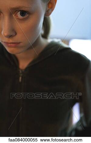 Stock Photography - Young woman with worried expression, cropped portrait. Fotosearch
