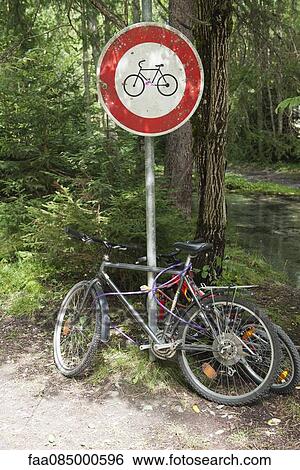 Bicycles locked to bicycle path sign View Large Photo Image Stock Photograph - Bicycles locked to bicycle path sign. Fotosearch