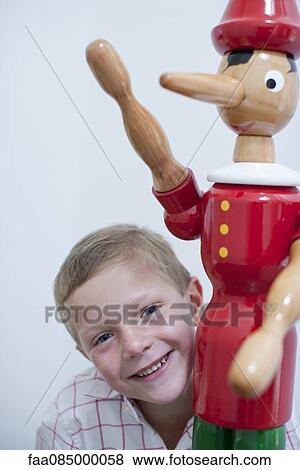 Boy and toy figurine View Large Photo Image Stock Photo - Boy and toy figurine. Fotosearch