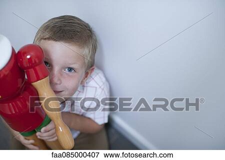 Stock Photo - Boy holding toy, high angle view. Fotosearch