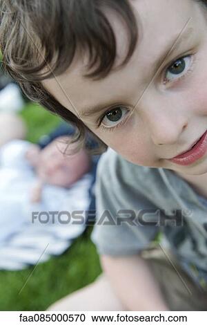Stock Image - Boy looking at camera, portrait. Fotosearch