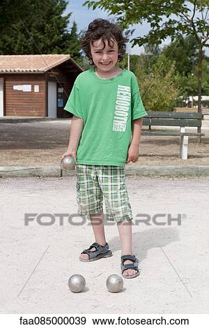Boy playing bocce ball View Large Photo Image Stock Photo - Boy playing bocce ball. Fotosearch
