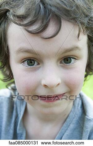 Stock Image - Boy smiling, portrait. Fotosearch