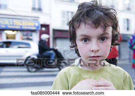 Picture - Boy standing on street. Fotosearch
