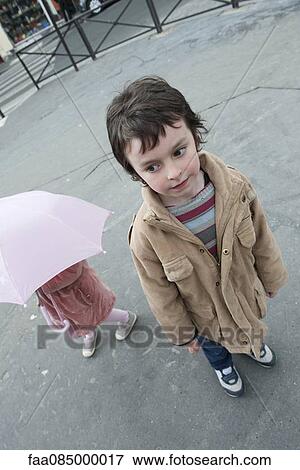 Boy standing outside with younger sister View Large Photo Image Stock Photo - Boy standing outside with younger sister. Fotosearch
