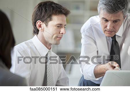 Business associates collaborating with laptop computer View Large Photo Image Stock Image - Business associates collaborating with laptop computer. Fotosearch