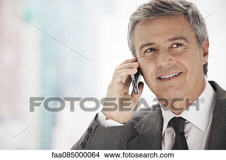 Business executive using cell phone, portrait View Large Photo Image Picture - Business executive using cell phone, portrait. Fotosearch